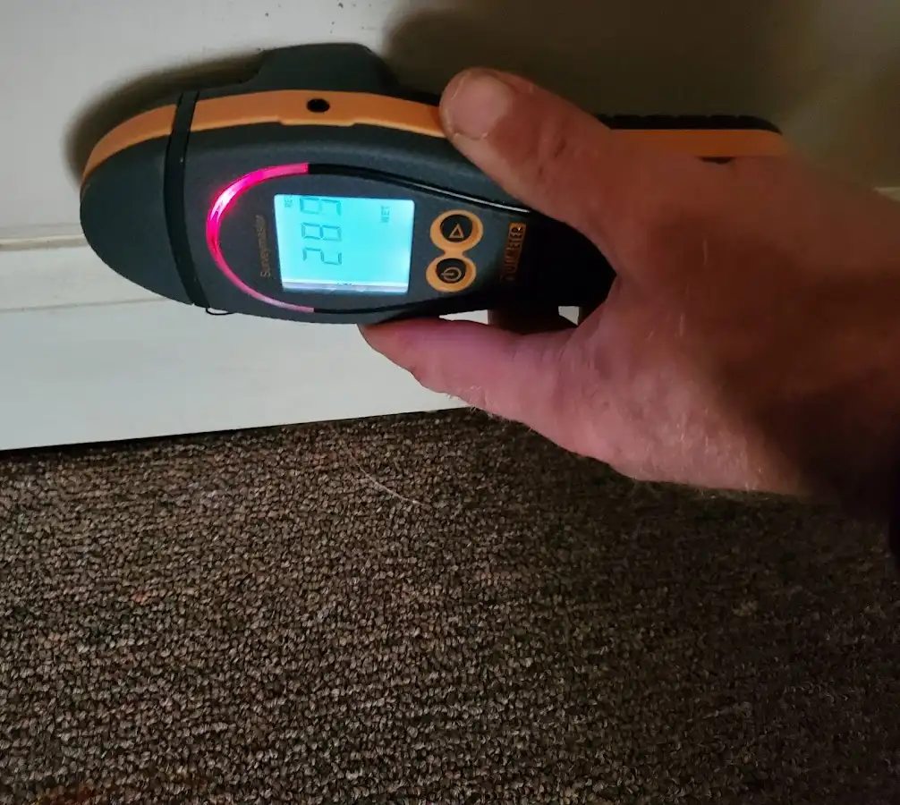 Moisture detection at baseboard during Storm Damage Restoration in Overlea